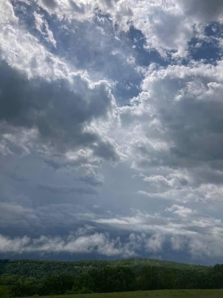 a cloud filled skies over a mountain range