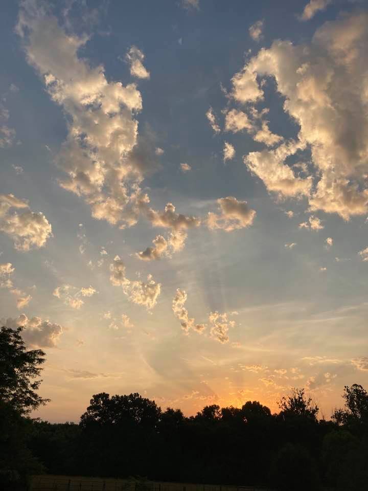 a colorful sunset sky with floating clouds