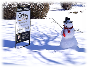 snowman next to a Century 21 LeMac realty sign