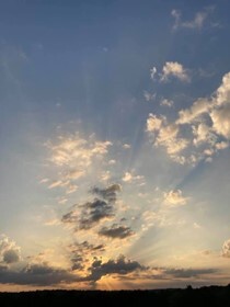 Clouds in the sky with the sun shining through.