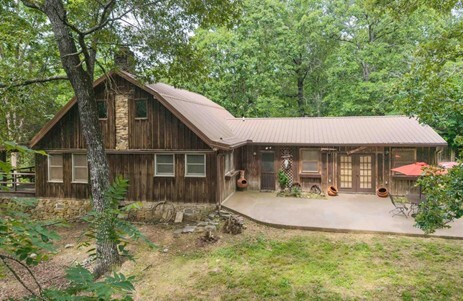 A wood house surrounded by trees.