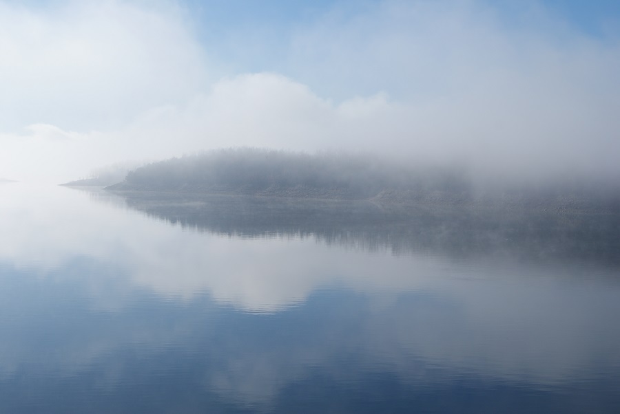 Blue sky with light fog over the lake