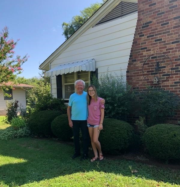 Danny Porter standing with Reagan after she purchased her new home